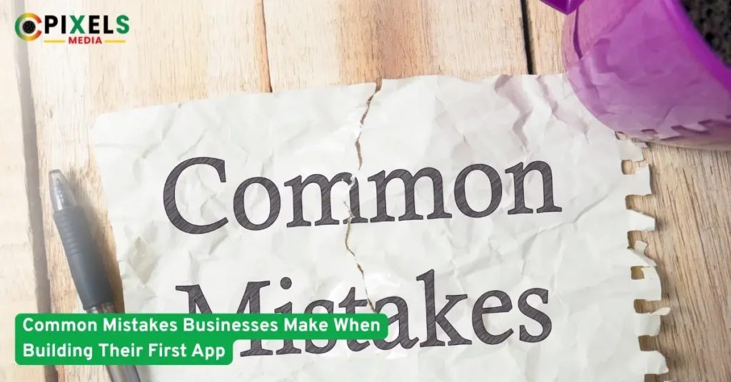 Crumpled paper reading 'Common Mistakes' on wooden table with pen and cup, symbolizing pitfalls of building first mobile app