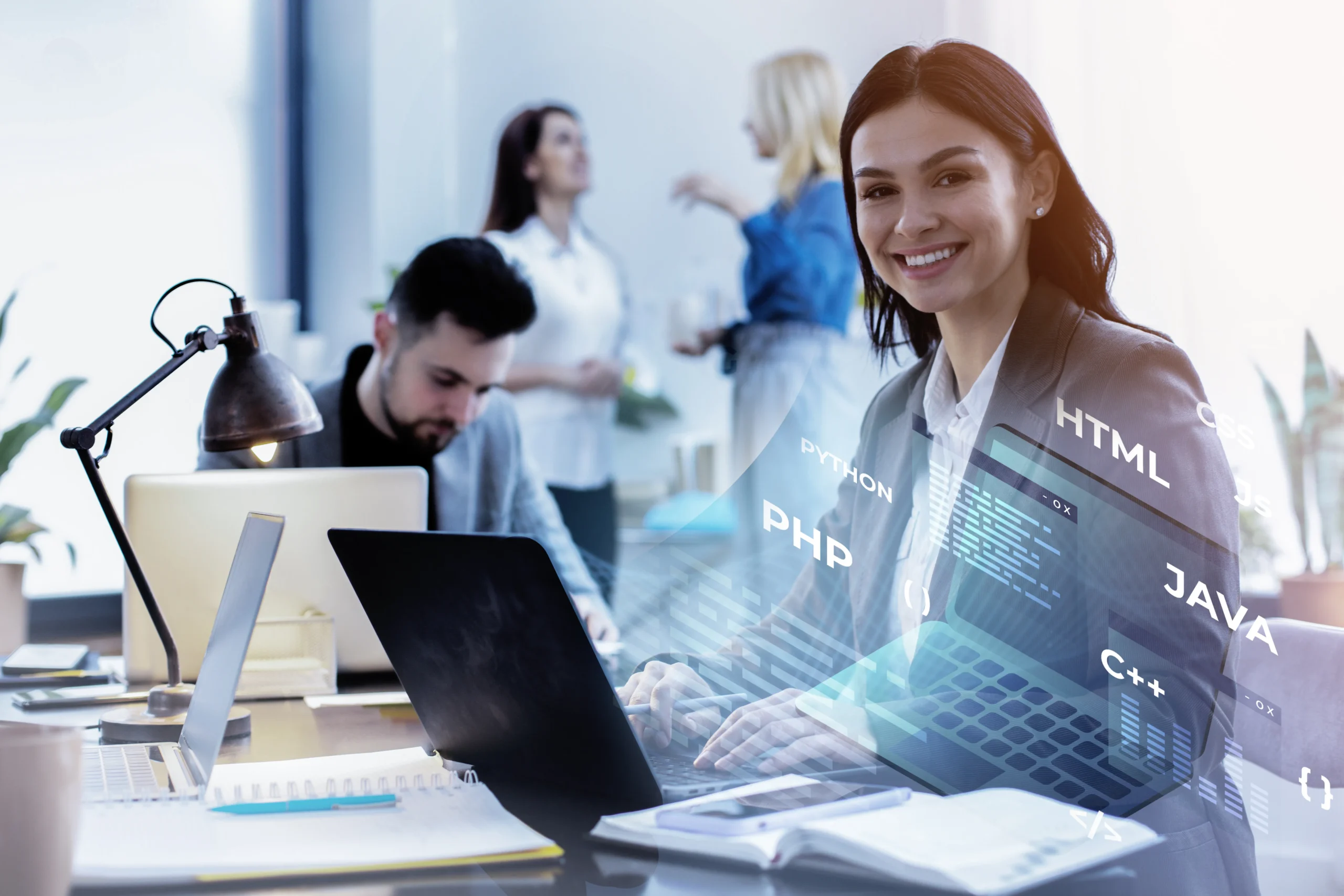 Web developer at a laptop with HTML, PHP and JavaScript code graphics