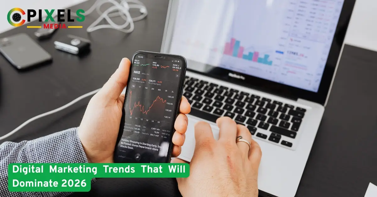 Hand holding smartphone with analytics charts beside laptop, showing marketing trends, data analysis, and growth strategies.